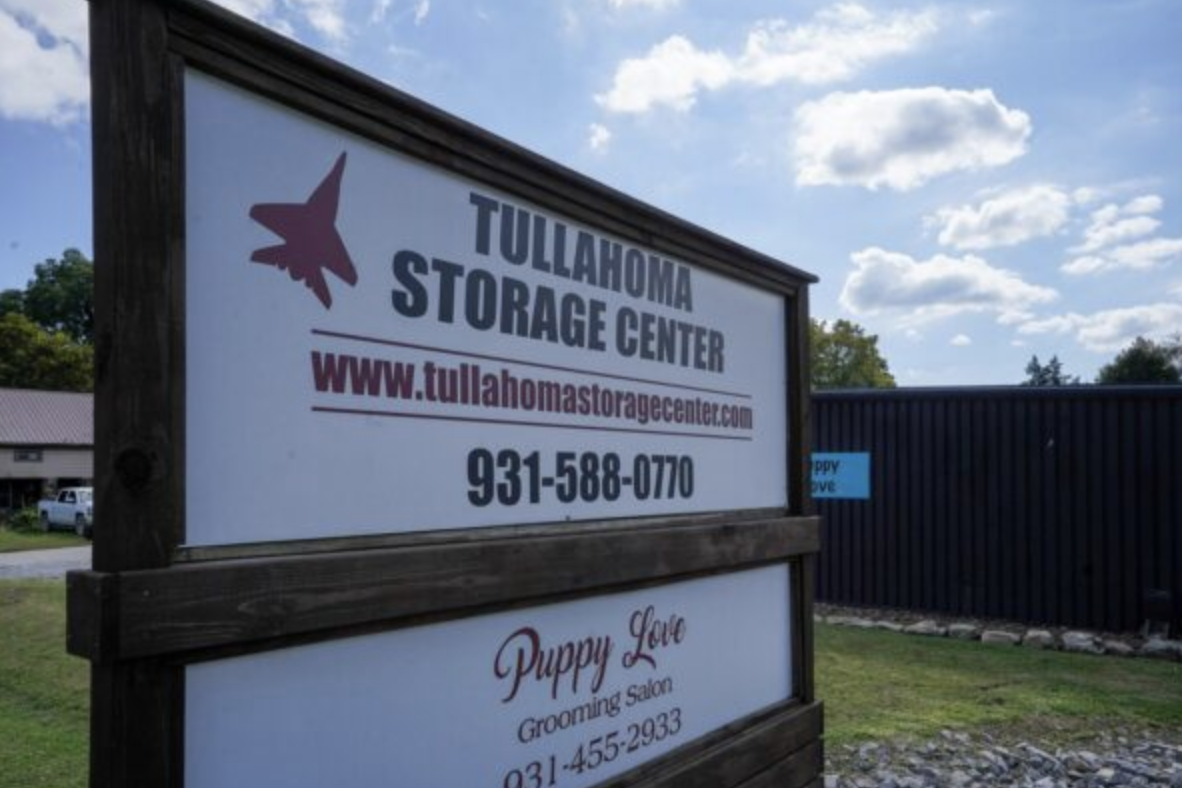 Tullahoma Storage Center sign showing the website and phone number in front of the storage buildings